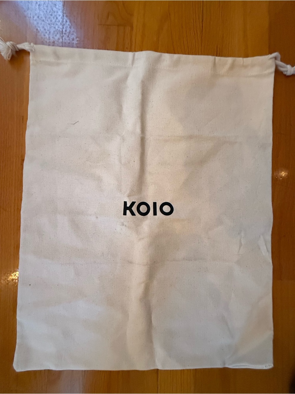 KOIO Cream Drawstring Dust Bag with Black Logo
